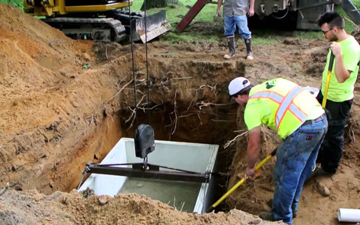 Heavy excavator preparing a residential site for foundation protection and drainage system installation in Savannah, GA